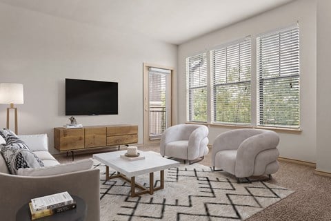 a living room with two chairs and a coffee table and a television